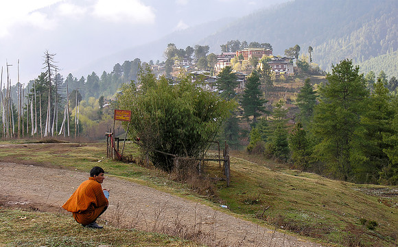 A man waiting on the road to distant Gangtey Gompa, Bhutan 2005
